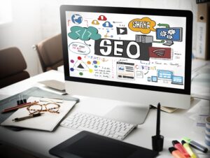 SEO strategy concept on computer screen with digital marketing elements, keywords, content, and website optimization visuals in a modern workspace.