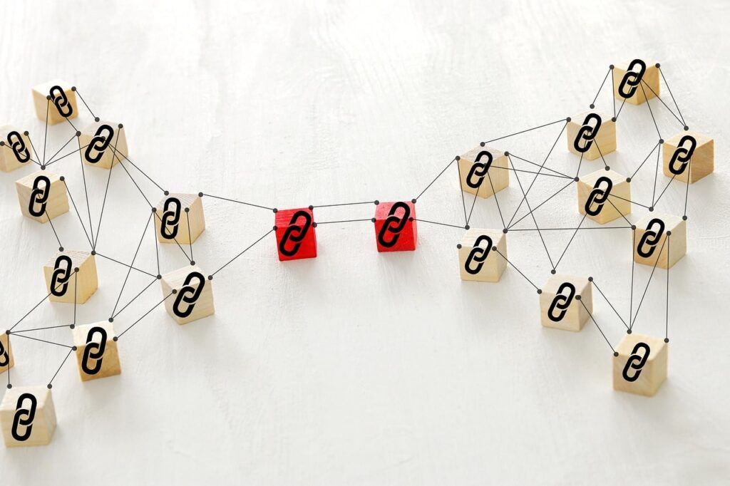 Conceptual illustration of backlink network structure with interconnected wooden blocks and chain link icons representing SEO and link building